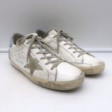 1) Golden Goose Superstar sneakers, white leather with blue accents, authentic pre-owned, good condition 2) Golden Goose white leather Superstar sneakers with blue star detail, authentic pre-owned women's shoes 3) Authentic pre-owned Golden Goose Superstar leather sneakers in white with blue trim, luxury casual wear