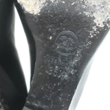 Chanel CC cap-toe chain-trimmed wedge pumps in black leather, authentic pre-owned with visible wear