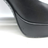 Chanel cap-toe platform pumps in black leather and patent, pre-owned with light scuffs, size 35.5