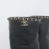 Chanel CC chain-trim cap-toe knee-high boots in black leather, pre-owned with authentic designer detailing