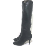Chanel knee-high cap-toe boots in black leather with CC chain trim — pre-owned, authentic luxury