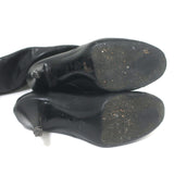 Chanel knee-high cap-toe boots in black leather with CC chain trim, authentic pre-owned, size 36.5