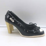 Chanel 06P bow cap-toe pumps in black-and-white patent leather, authentic pre-owned luxury.