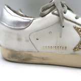 Golden Goose Superstar white leather sneakers with silver glitter star, authentic pre-owned designer pair.