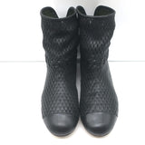 Authentic Chanel cap-toe perforated leather flat ankle boots in black, pre-owned and gently worn