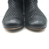 Chanel cap-toe perforated leather flat ankle boots in black, pre-owned, gently worn