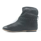 Authentic Chanel perforated cap-toe flat ankle boots in black leather, gently pre-owned