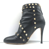 Authentic Valentino Rockstud bow ankle boots in black leather, pre-owned with visible wear and tarnished studs.