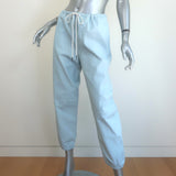 Pre-owned SPRWMN light blue leather drawstring joggers, authentic luxury, gently worn with minor waistband scuffs.