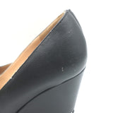 Chanel wedge pumps with CC cap toe and chain trim in black leather, pre-owned luxury with visible wear, size 35.5