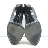 Chanel cap-toe platform pumps in black leather and patent, pre-owned with minor scuffs, authentic luxury heels