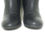 Chanel knee-high boots, CC chain-trim cap toe in black leather — authentic pre-owned luxury, size 36.5