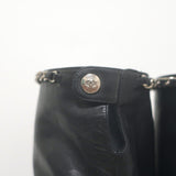 Chanel CC chain-trim cap-toe knee-high boots in black leather, authentic pre-owned luxury.