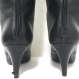 Chanel knee-high cap-toe boots in black leather with CC chain trim, authentic pre-owned luxury, size 36.5