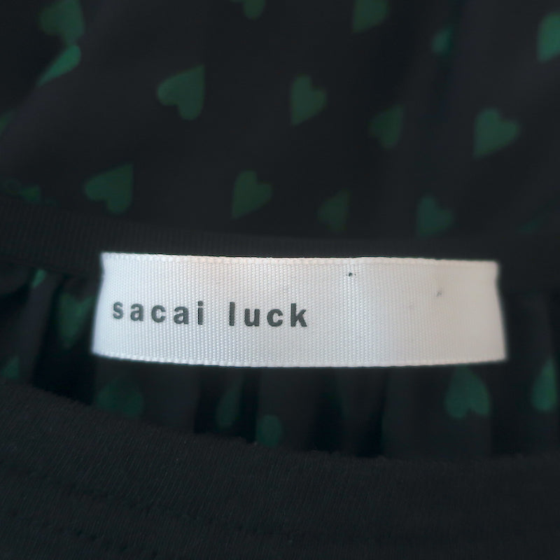 Sacai Luck black linen-blend tiered-back cap-sleeve tee with heart print — pre-owned, authentic luxury, gently worn.