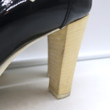 Chanel cap-toe pumps with bow in black and white patent leather, pre-owned, authentic Parisian luxury.
