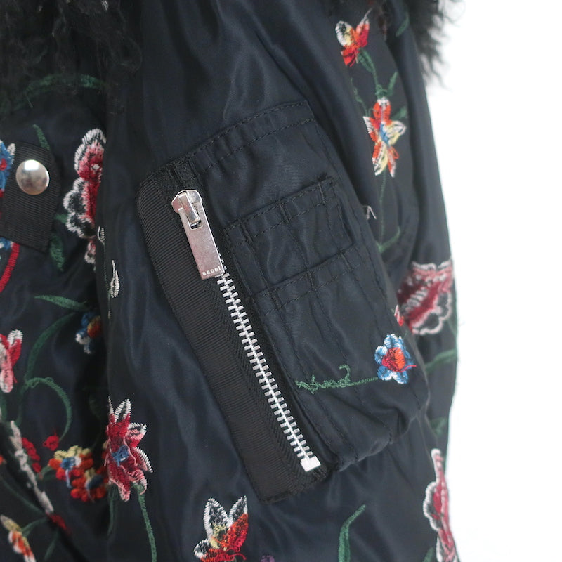 Sacai floral-embroidered black bomber jacket with lamb-fur collar, authentic pre-owned, gently worn luxury piece