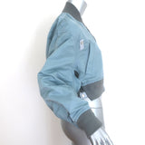 Sacai cropped MA-1 padded bomber jacket, light blue nylon, pre-owned with light wear — authentic designer piece