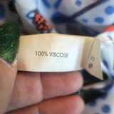 Poupette St Barth Mila tassel-embellished mini dress in white and blue, lightweight woven fabric, authentic pre-owned