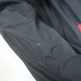 Authentic Prada Linea Rossa black nylon zip-up jacket with graphic patch embellishments, pre-owned luxury piece