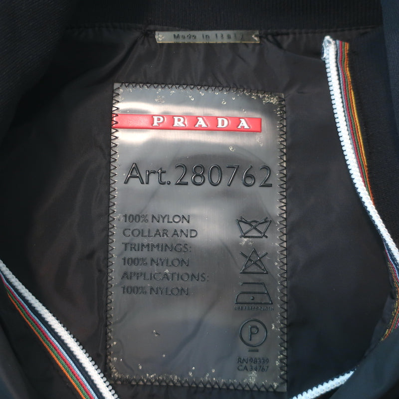 Prada Linea Rossa black nylon zip-up jacket with graphic patch embellishments, pre-owned luxury piece