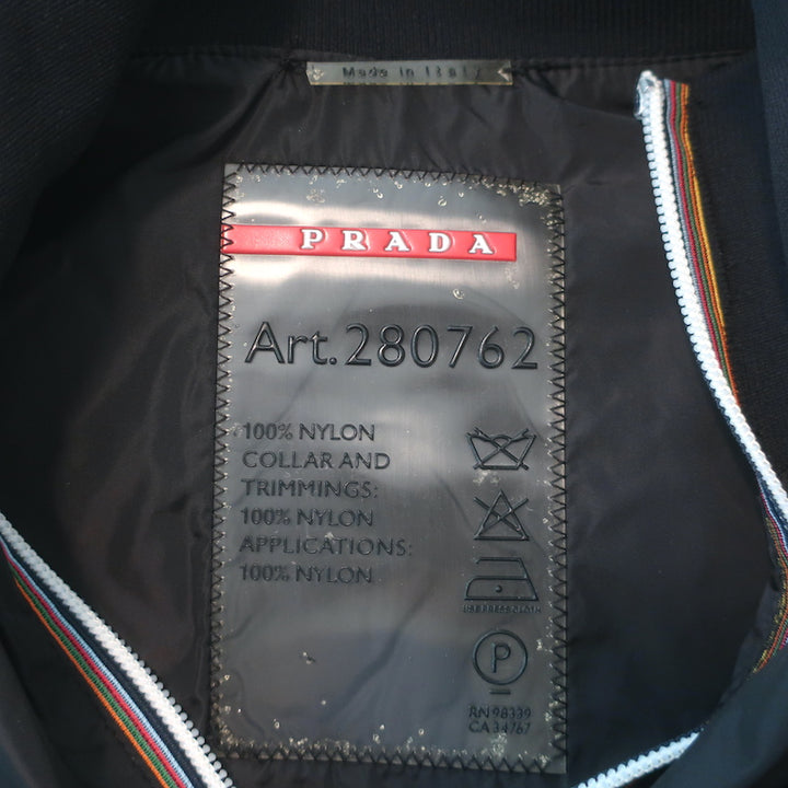 Prada Linea Rossa black nylon zip-up jacket with graphic patch embellishments, pre-owned luxury piece