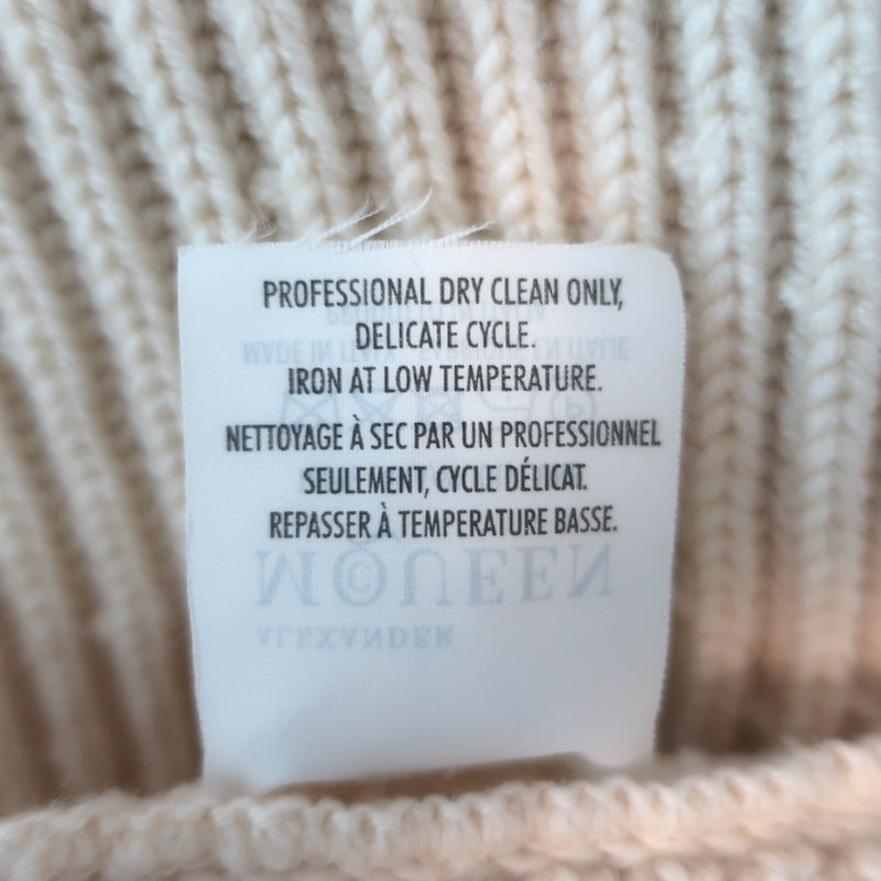 Alexander McQueen ribbed wool peplum cardigan in ivory, pre-owned with minor wear; luxury designer knit, size Large