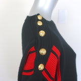 Alexander McQueen cashmere buttoned-shoulder sweater in black with red trim, authentic pre-owned, gently worn luxury piece.