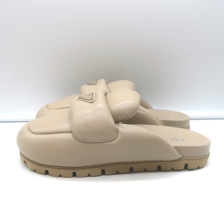 Prada triangle-logo padded flat mules in nude leather, authentic pre-owned (new without tags)