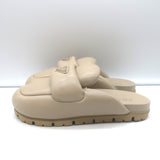 Prada triangle-logo padded flat mules in nude leather, authentic pre-owned (new without tags)
