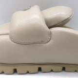 Authentic Prada padded flat mules in nude leather with triangle logo, pre-owned (new without tags)