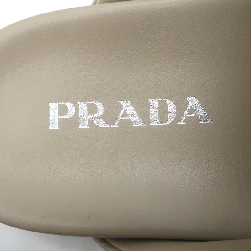 Prada triangle-logo padded flat mules, nude leather, pre-owned (new without tags), authentic luxury women&