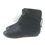 Authentic Chanel cap-toe perforated black leather flat ankle boots, gently pre-owned