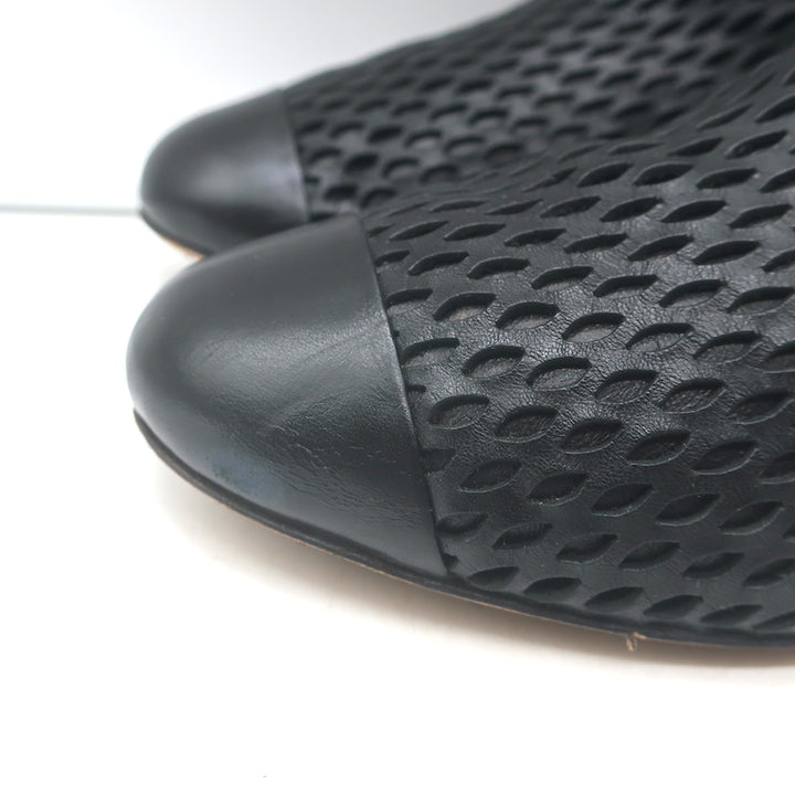 Authentic Chanel perforated cap-toe leather flat ankle boots in black, pre-owned, gently worn, size 38