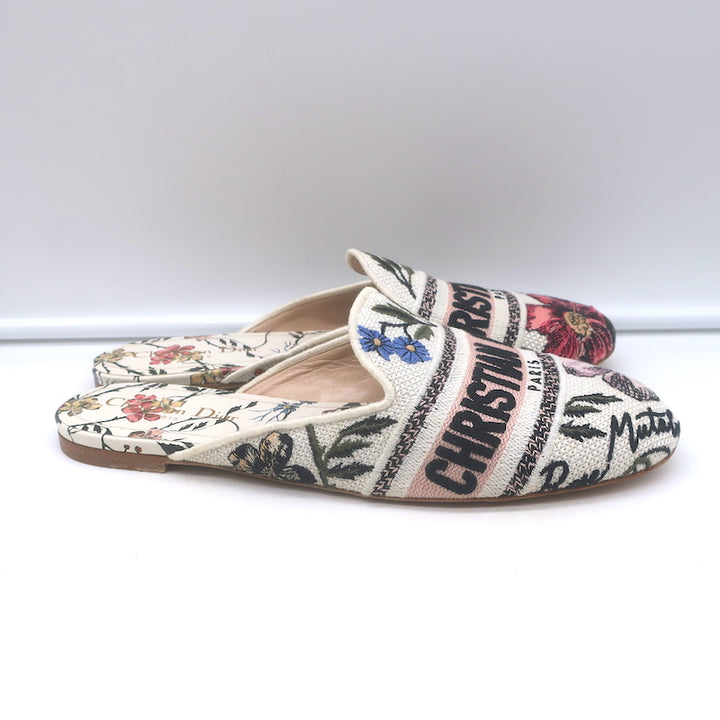 Authentic Christian Dior canvas floral-embroidered flat mules in white/multi, pre-owned and gently worn luxury flats