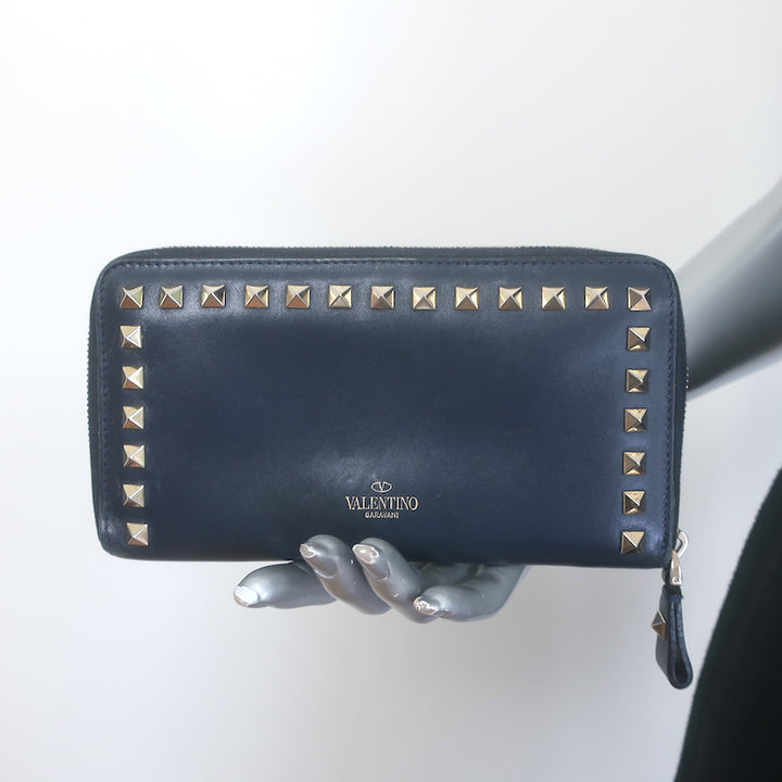Valentino Rockstud zip-around wallet in dark navy leather with gold hardware, pre-owned authentic luxury