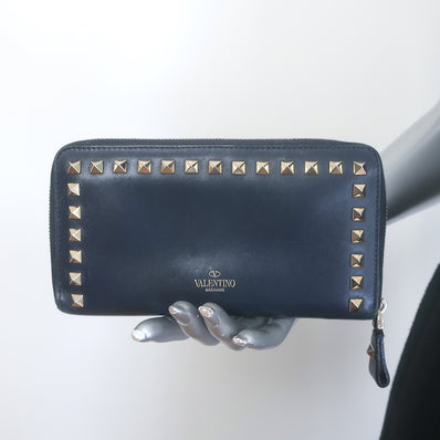 Valentino Rockstud zip-around wallet in dark navy leather with gold hardware, pre-owned authentic luxury