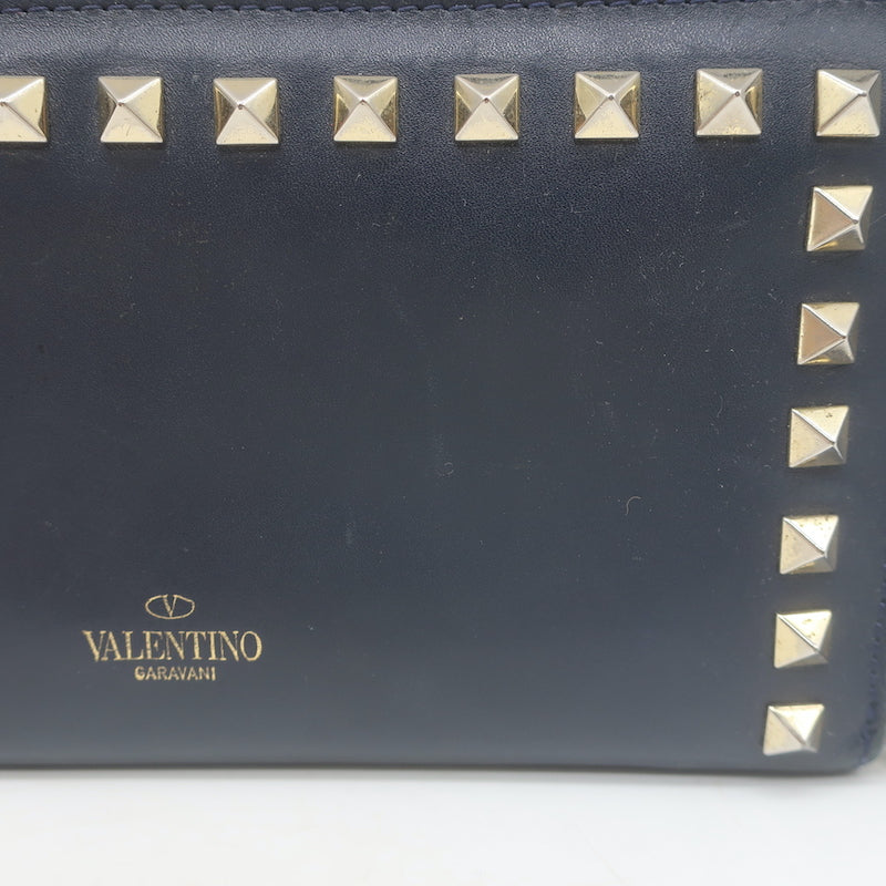 Authentic Valentino Rockstud zip-around wallet in dark navy leather, pre-owned with gold hardware and light wear