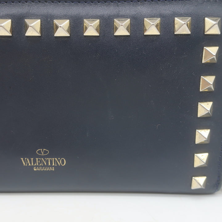 Authentic Valentino Rockstud zip-around wallet in dark navy leather, pre-owned with gold hardware and light wear