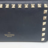 Authentic Valentino Rockstud zip-around wallet in dark navy leather, pre-owned with gold hardware and light wear