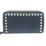 Valentino Rockstud zip-around wallet in dark navy leather with gold hardware — pre-owned, authentic luxury.