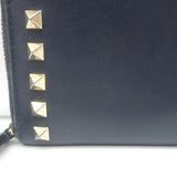 Authentic Valentino Rockstud zip-around wallet in dark navy leather with gold hardware, pre-owned.