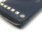 Authentic Valentino Rockstud zip-around wallet in dark navy leather with gold hardware, pre-owned with light wear.