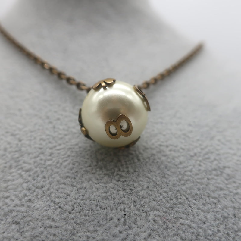 Christian Dior Tresor De Tribale Faux Pearl Pendant Necklace Brass