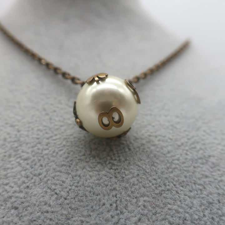 Christian Dior Tresor De Tribale Faux Pearl Pendant Necklace Brass
