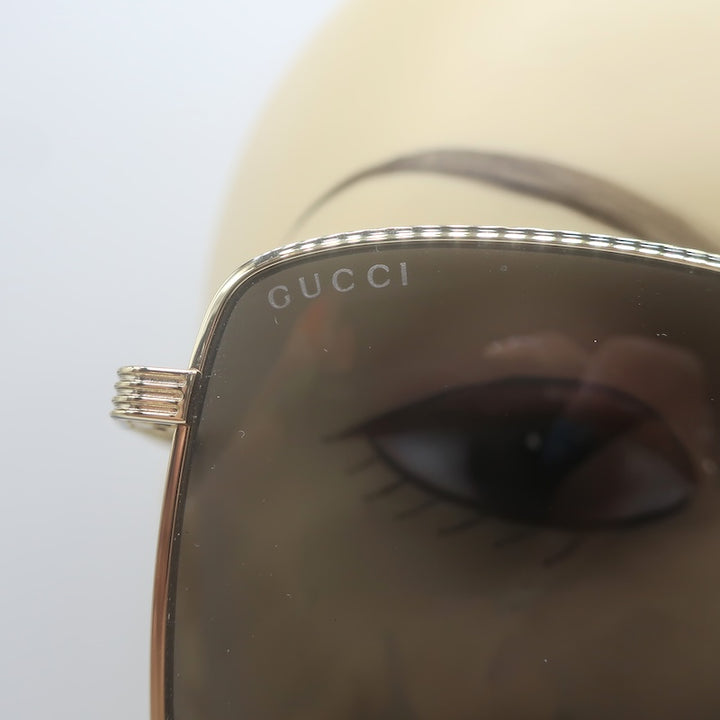 Gucci GG0802S, GUCCI etched on left lens and beaded gold rim