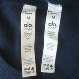 Alo Yoga cashmere V-neck sweater and flared pants set in navy — authentic pre-owned, gently worn luxury.