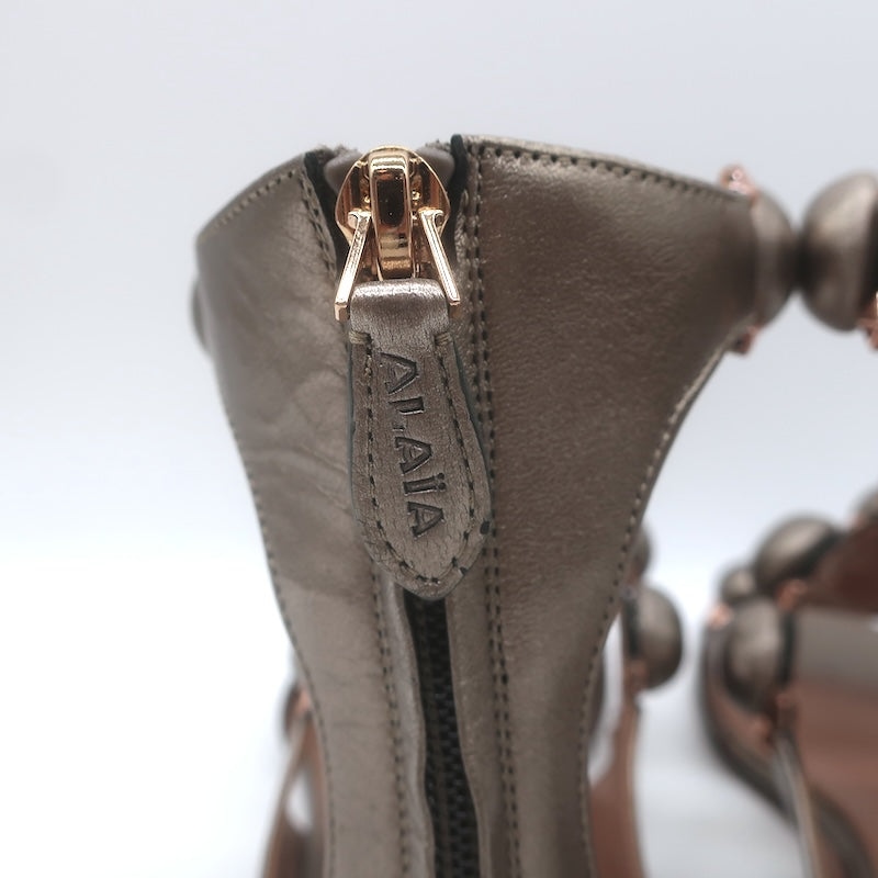 Alaia La Bombe Studded Flat Gladiator Sandals Rhodium Metallic Leather Size 37.5